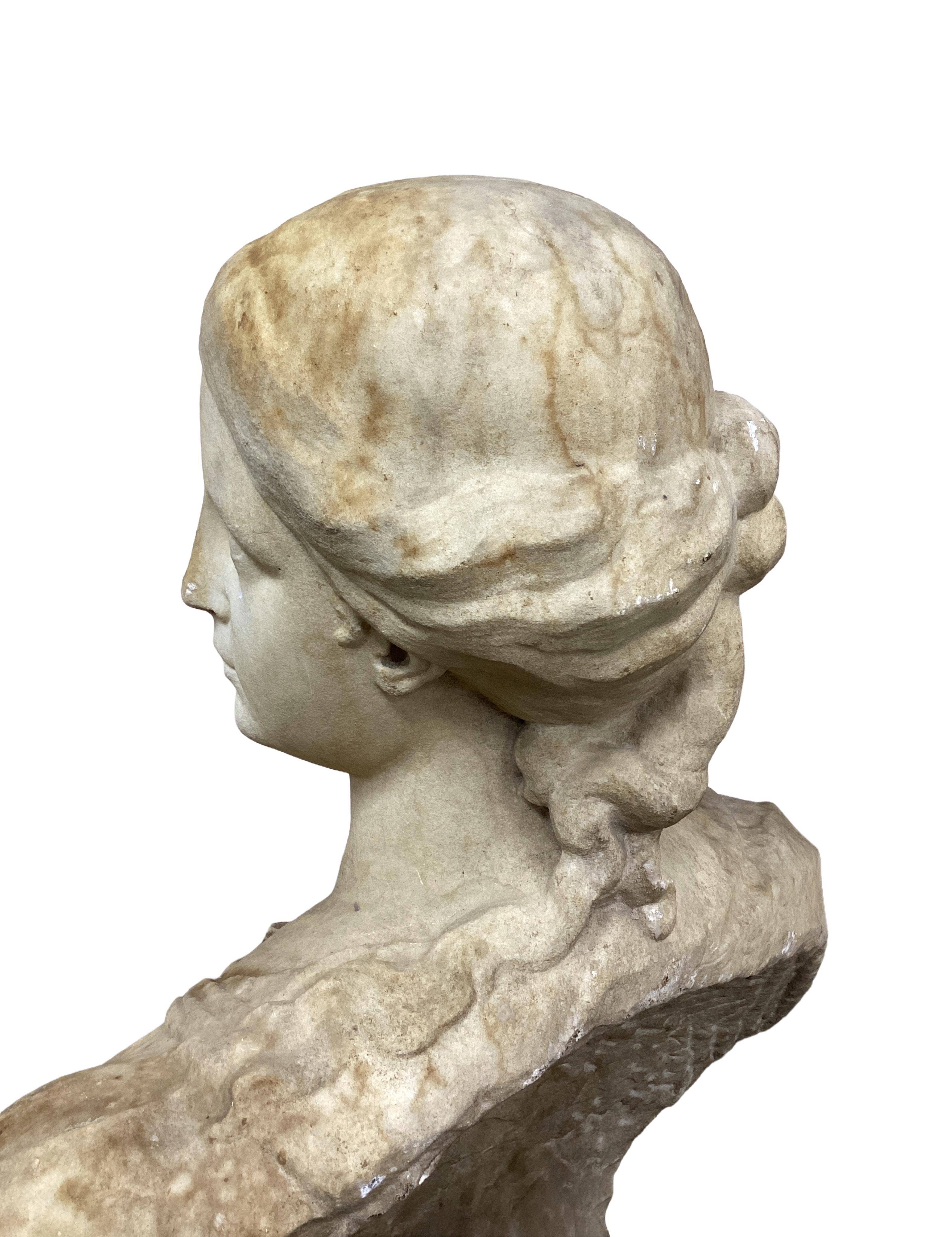 An oversized white marble bust of a classical maiden, 19th century